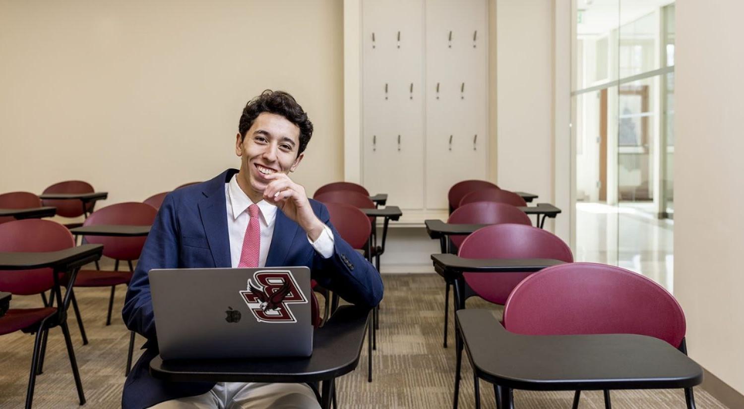 Luke Stanise sitting at a desk with a laptop